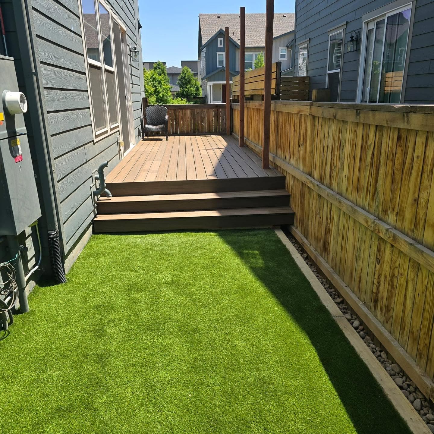 Two-tier composite deck with artificial turf and metal railing