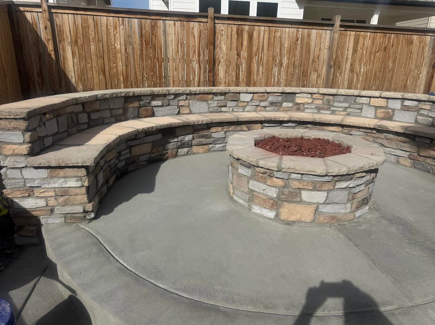 Curved stone bench seating with central fire pit